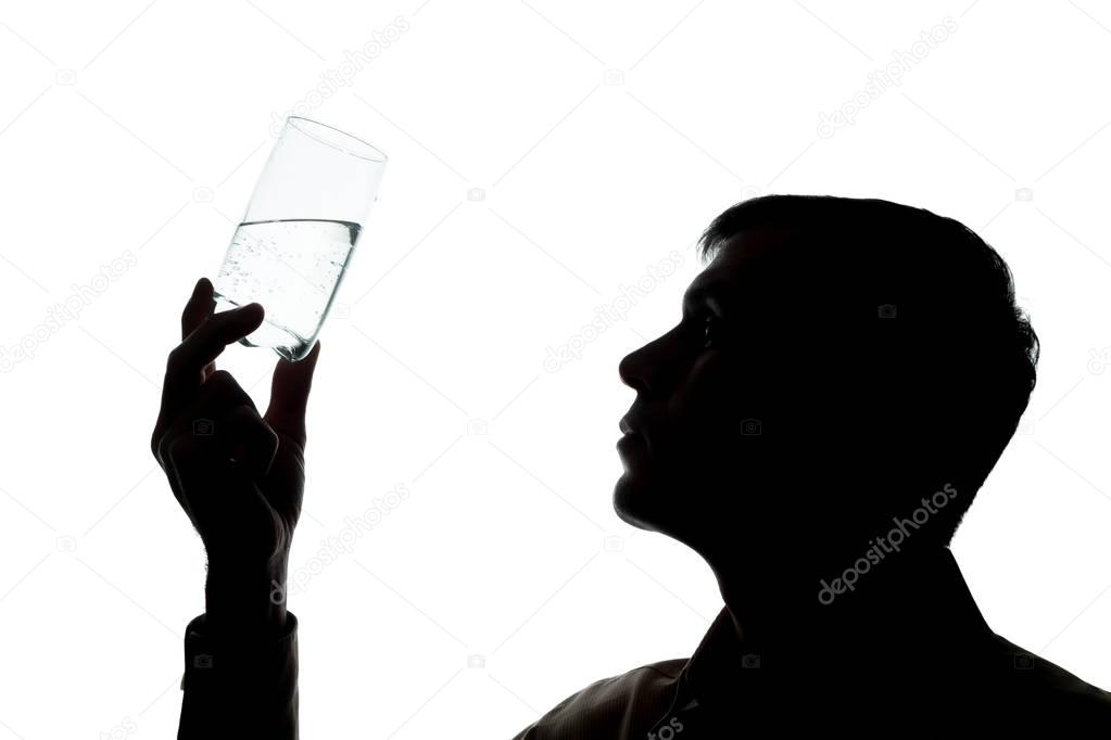Young man drinks, checks the quality of soda water - silhouette