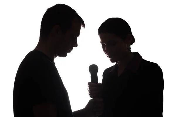 Young man and woman singing into the microphone — Stock Photo, Image