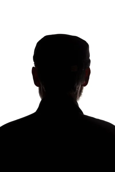 Stary człowiek w szczytowej czapce, widok z tyłu - ciemna sylwetka z bliska — Zdjęcie stockowe