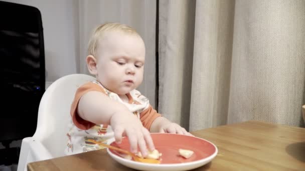 Funny cute baby eating banana — Stock Video © Rammellzee #128348080