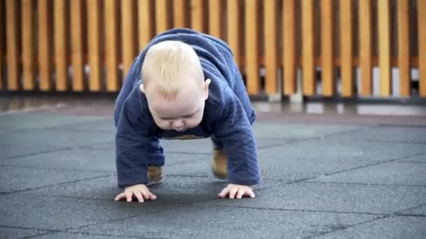 Één jaar oude baby staande omhoog op zijn eigen. — Stockvideo