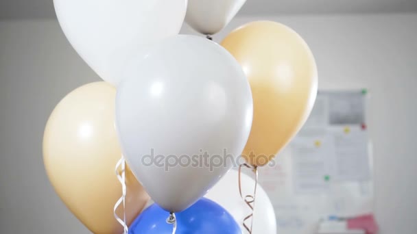 Hand with a knife pierces the balloons and they were blown away and explode. Slow motion. — Stock Video