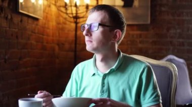 Genç adam yeme, restoranda kahvaltı