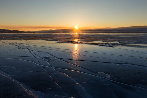 Texture of blue ice cracks of Lake Baikal at sunset. Olkhon isla — Stock Photo, Image