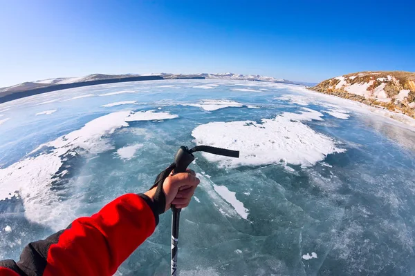 First person view gopro stick in his hand on the ice of Lake Bai — Stock Photo, Image