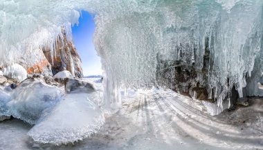 Panorama dawn in an ice cave with icicles on Baikal, Olkhon clipart