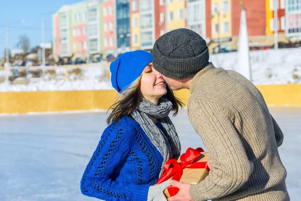 Mann schenkt seiner Freundin Überraschungsgeschenk für Urlaub und Kuss — Stockfoto