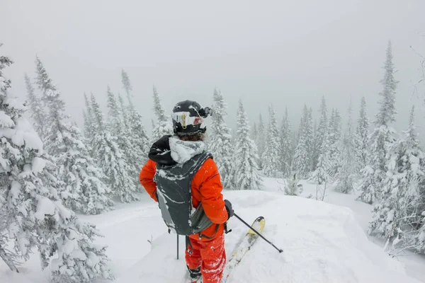 Man standing at top of ridge. Ski touring in mountains. Adventure winter freeride extreme sport — Stock Photo, Image