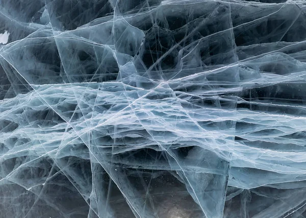 The gray ice of Lake Baikal in many white cracks near the background graphic resource — Stock Photo, Image