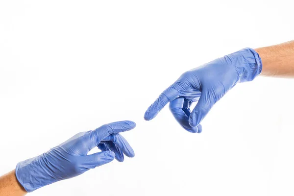 Hands of people in medical colorful rubber gloves reaching out for each other — Stock Photo, Image