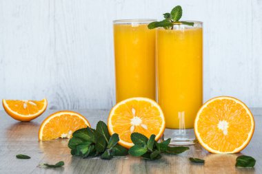 Gözlüklü hafif ahşap arka plan, nane ile portakal suyu