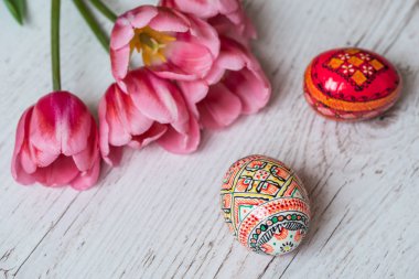 Paskalya Paskalya yumurtaları ve hafif ahşap zemin üzerine Pembe Lale arka plan