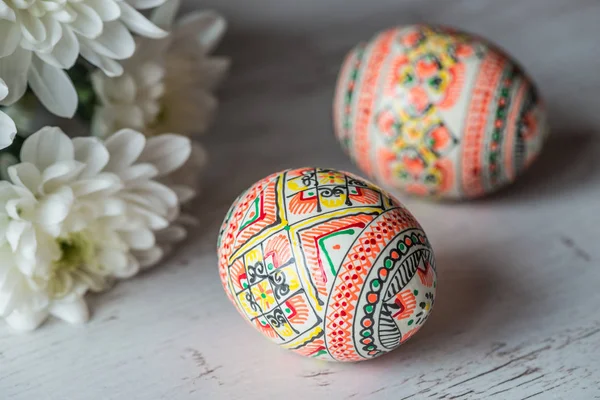 Fondo de Pascua con huevos de Pascua y flores de primavera sobre fondo de madera clara — Foto de Stock