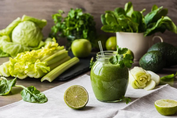 Diety detoks. Zielony koktajl z różnych warzyw na podłoże drewniane — Zdjęcie stockowe
