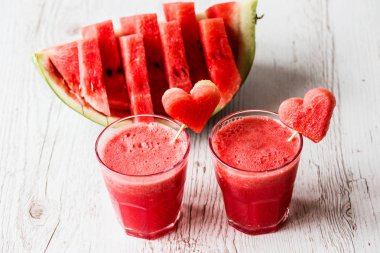 sağlıklı içecekler. Beyaz ahşap zemin üzerinde bir kalp ile karpuz güler yüzlü