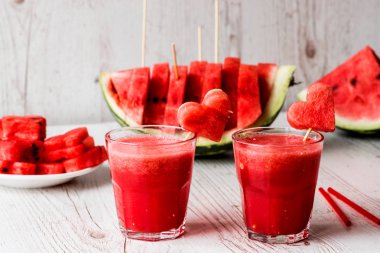 sağlıklı içecekler. Beyaz ahşap zemin üzerinde bir kalp ile karpuz güler yüzlü