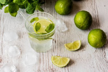 Mojito kokteyl limon, nane ve buz Beyaz ahşap zemin üzerinde.