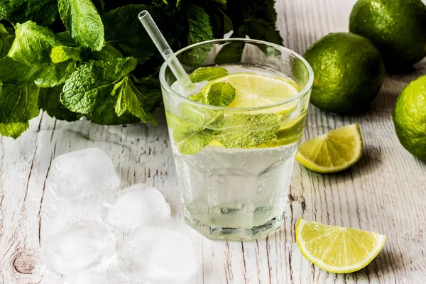 Mojito kokteyl limon, nane ve buz Beyaz ahşap zemin üzerinde.