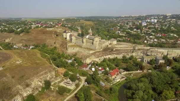 Aerial view of Kamianets-Podilskyi castle in Ukraine. The fortress located among the picturesque nature in the historic city of Kamianets-Podilskyi, Ukraine. — Stock Video