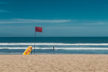 Kuta beach, bali, Endonezya. Surf kurtarma noktası. Sarı kurtarma sörf tahtası ve kırmızı bayrak.