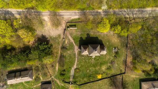 Aerial view over traditional Ukrainian village in spring. Museum of national architecture in Pirogovo in a beautiful summer day, Kiev, Ukraine