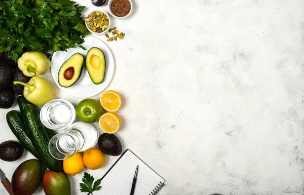 Preparing vegetables and fruits for preparing healthy food. Notebook for writing cooking recipes. Top view. Copy space text.