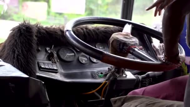 A driver drives a bus in Asia. Close-up of the steering wheel and hands. — 비디오
