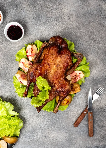 Roasted duck with apples and herbs on a festive dish. Christmas symbolic food. Top view. — 스톡 사진