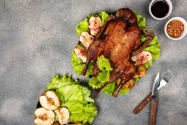 Roasted duck with apples and herbs on a festive dish. Christmas symbolic food. Top view. Copy space for text. — 스톡 사진