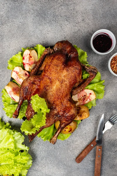 Roasted duck with apples and herbs on a festive dish. Christmas symbolic food. Top view. — 스톡 사진