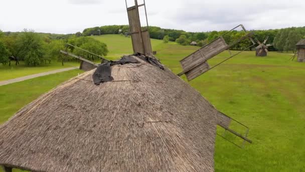 Old wooden windmill in a field and sky. — Stock Video