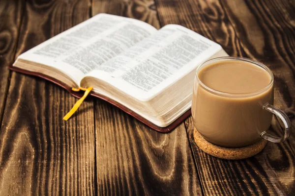 Bible and coffee with milk on wooden background — Stock Photo, Image