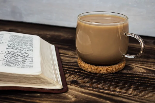 Bible and coffee with milk on wooden background — Stock Photo, Image