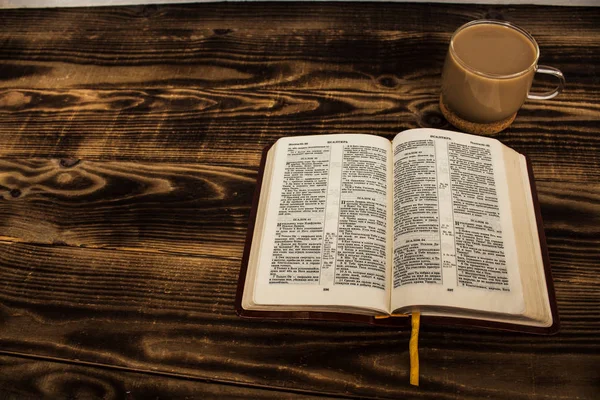 Bible and coffee with milk on wooden background — Stock Photo, Image