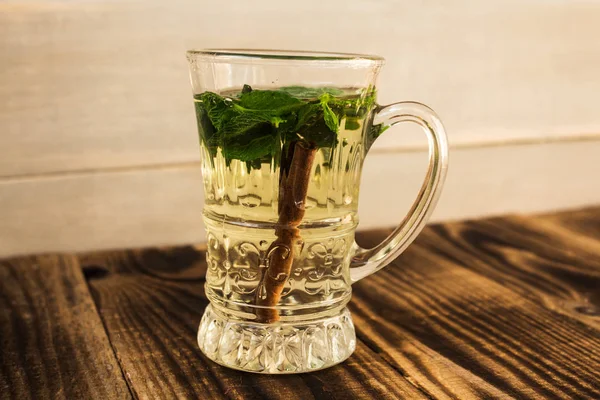 clear cup with mint and cinnamon stick tea