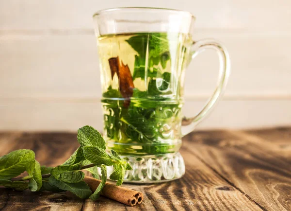 clear cup with mint and cinnamon stick tea