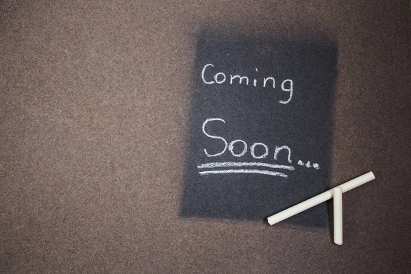 coming soon sign made chalk on a blackboard