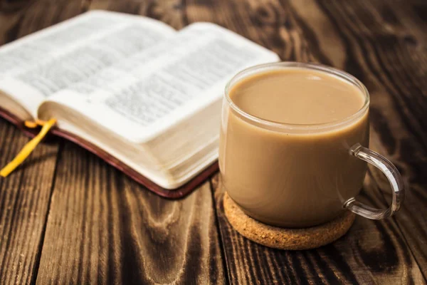 A cup of coffee and bible on wooden background — Stock Photo, Image