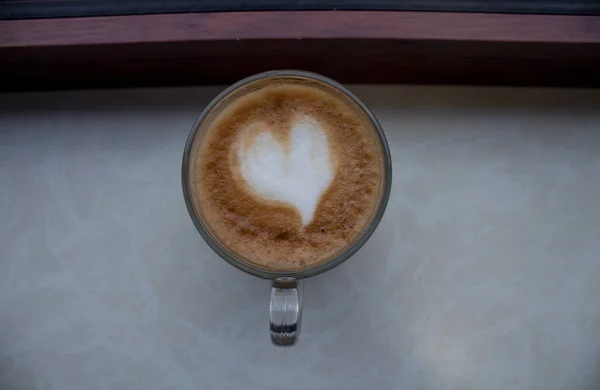 A cup of coffee with a heart of foam — Stock Photo, Image