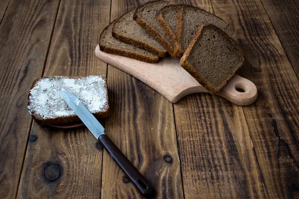 corn bread cut into pieces and butter on a wooden background