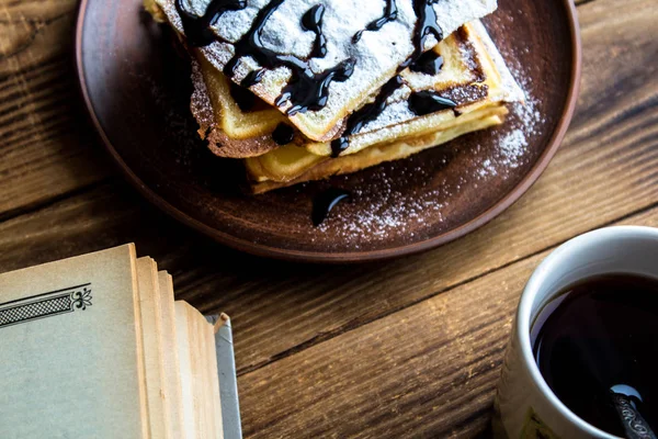 A cup of tea and a pile of wafers and book — Stock Photo, Image