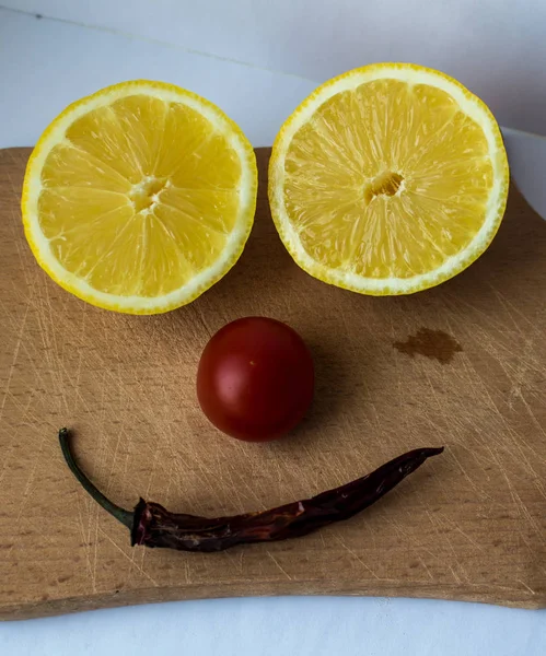 lemon cut into two parts tomato and pepper