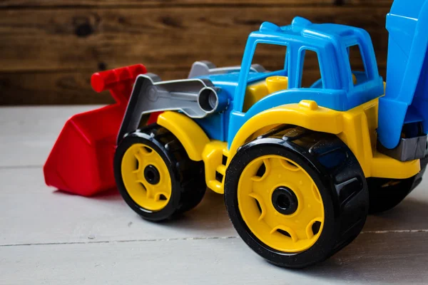 Niños juguetes tractor sobre fondo de madera — Foto de Stock