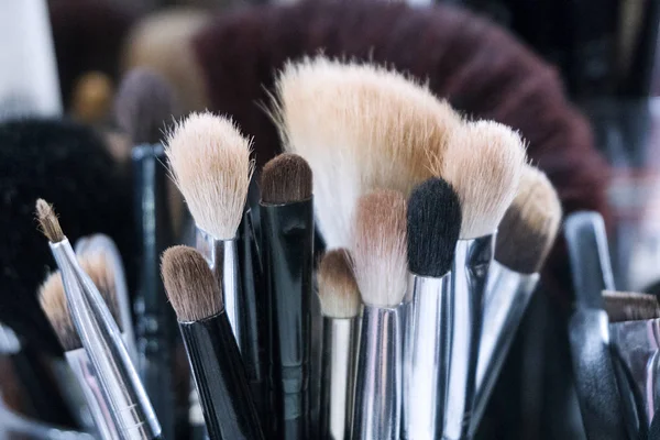 Professional makeup brushes in tube. Dirty makeup tools. — Stock Photo, Image