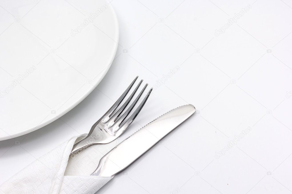 Knife and fork with serviette, isolated on the white background.