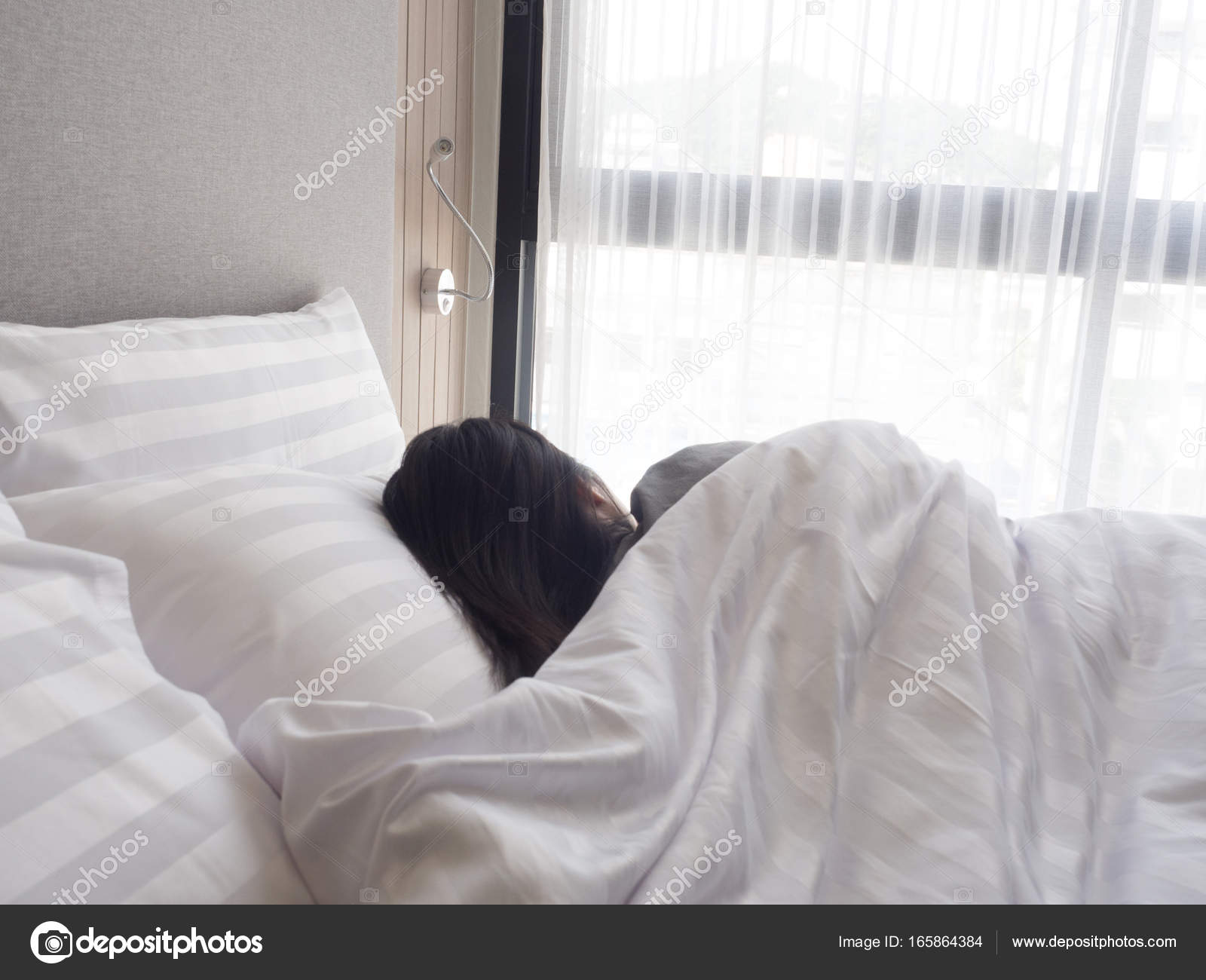 Sleeping woman cover face with blanket flat lay. Stock Photo by