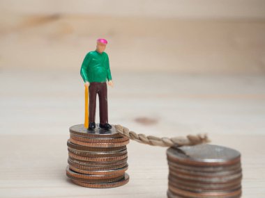 Para ve iş kavramı. Oldman küçük rakam ayakta üstte