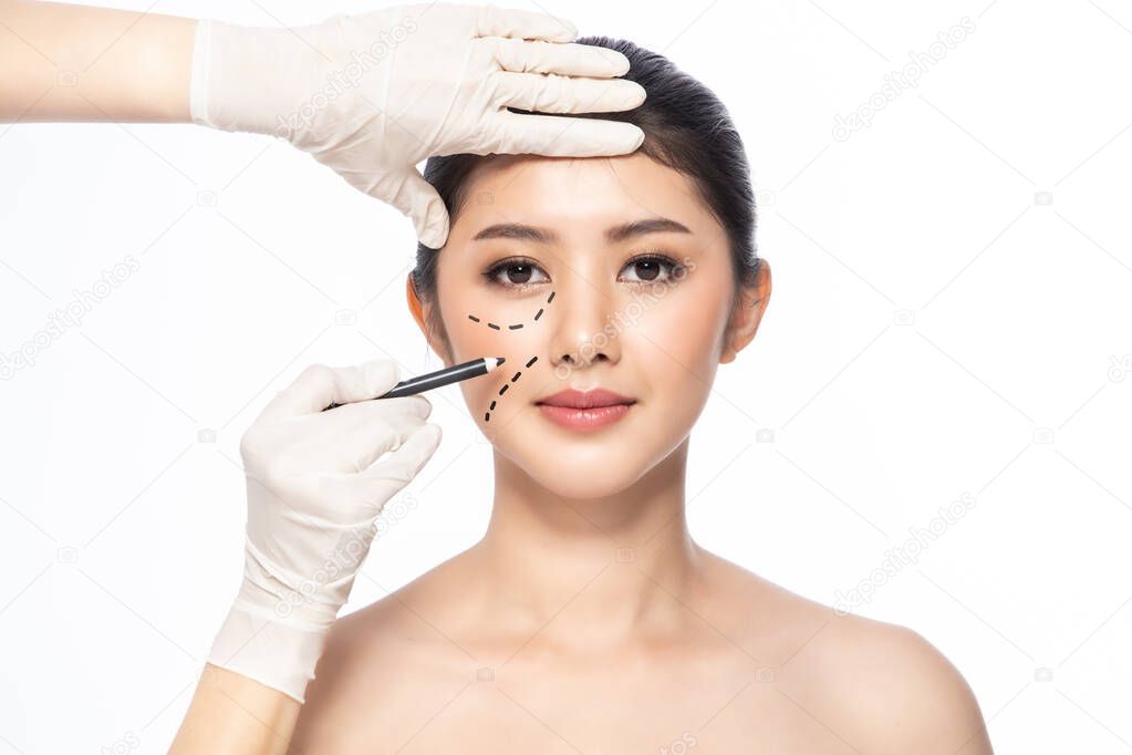 Lines on face, close up, plastic surgery concept, doctor's hand 