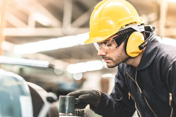 Industrial Engineers in Hard Hats.Work at the Heavy Industry Manufacturing Factory.industrial worker indoors in factory. man working in an industrial factory.