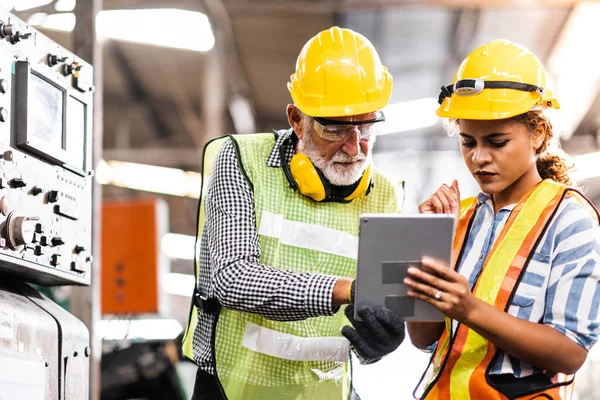 Industrial Engineers in Hard Hats.Work at the Heavy Industry Manufacturing Factory.industrial worker indoors in factory.aged man working in an industrial factory.